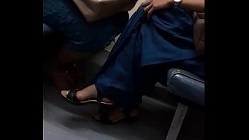 Girl in saree crossed legs inside the train